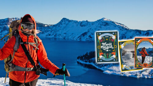 Skier at the rim of Crater Lake with promotional cards off to the side.