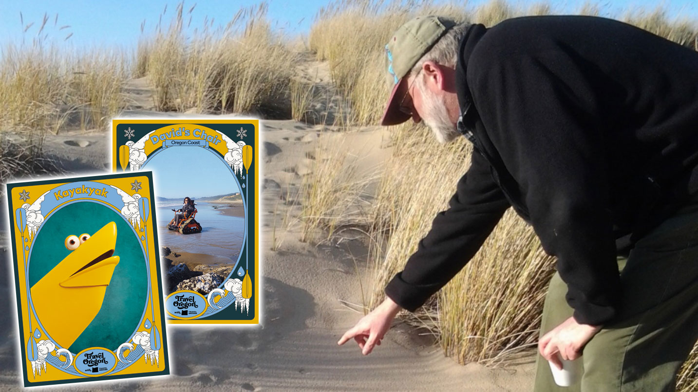 Man points to tracks in the sand. Kayakyak's card is displayed to the left.