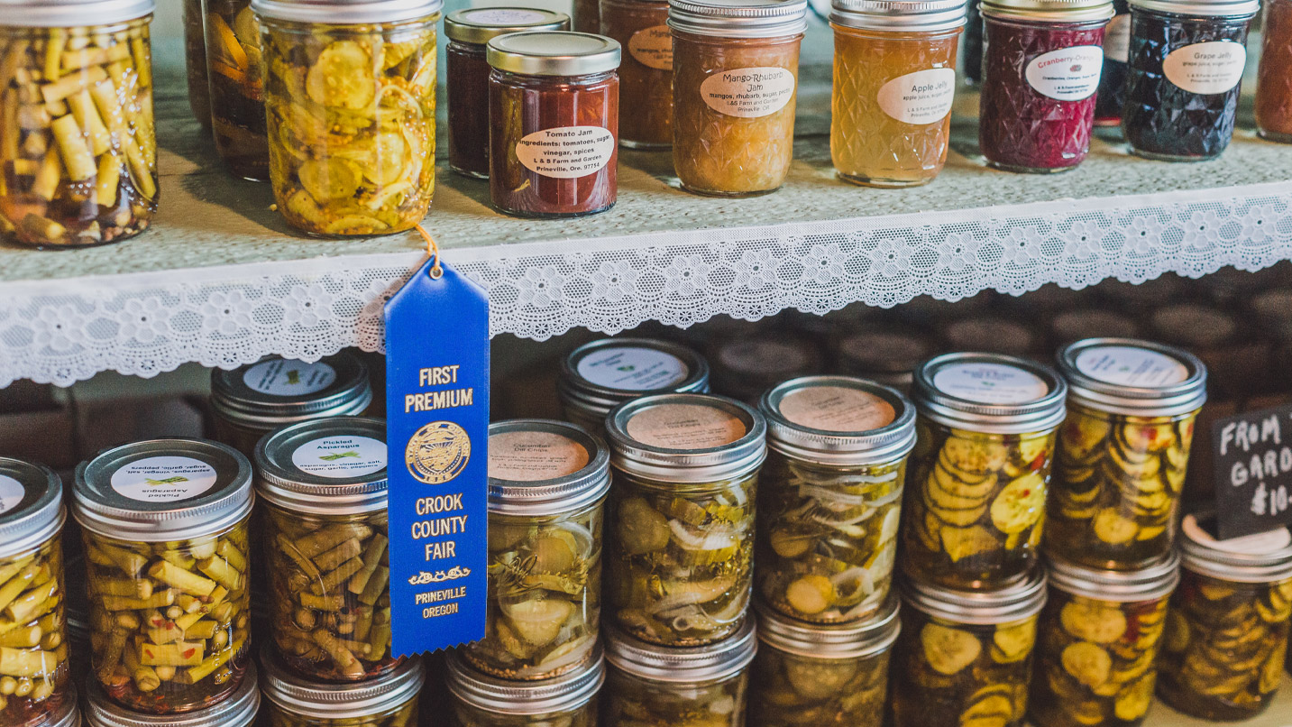 Jars of preserved food on display, with a blue ribbon prize from Crook Country Fair.
