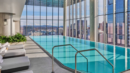 Long pool with windows that look out to city view