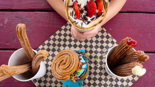 Various Mexican desserts sit on a picnic table.