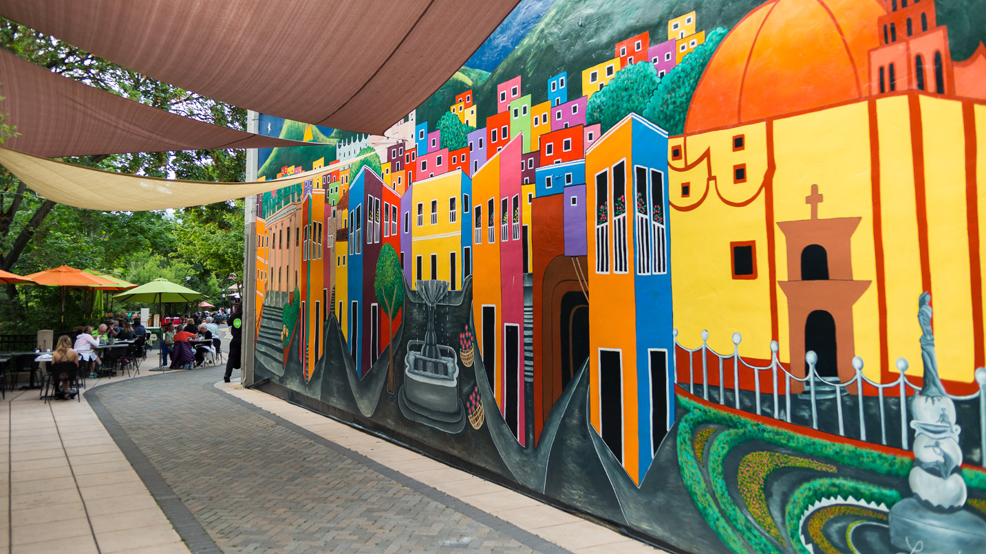 A colorful mural of painted homes and a plaza of the Mexican city of Guanajuato.