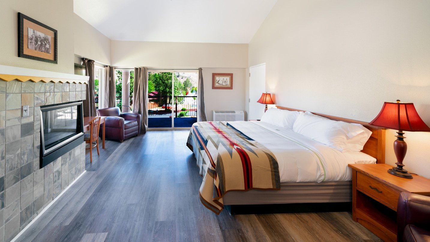 Interior of hotel room with large king size bed.