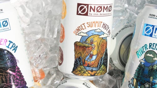 Cans of Crux's non-alcoholic beers on ice.