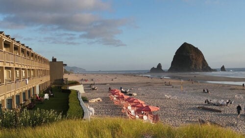 A beachside hotel with balconies overlooking the ocean.