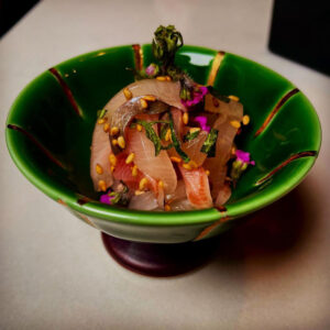 Fresh fish served in a green bowl.