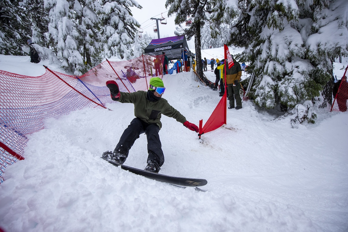 A snowboarder turns around a gate on the Dirksen Derby race course.