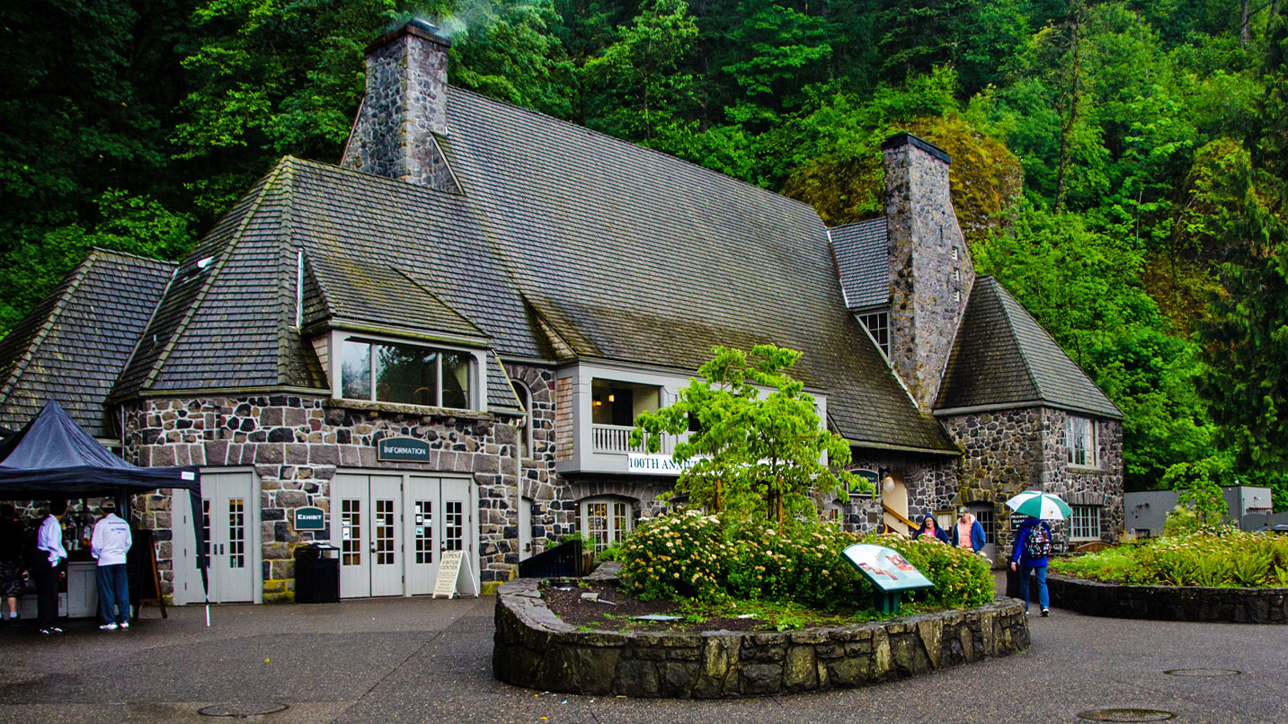 A large lodge and visitor center on a fall day.