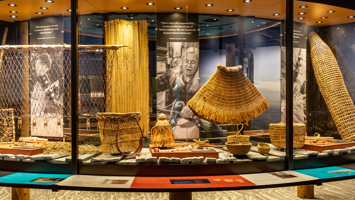 A glass-encased exhibit displaying woven baskets.