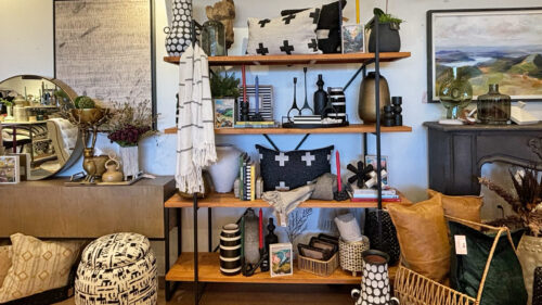 A home store interior with vases, candles and pillows.