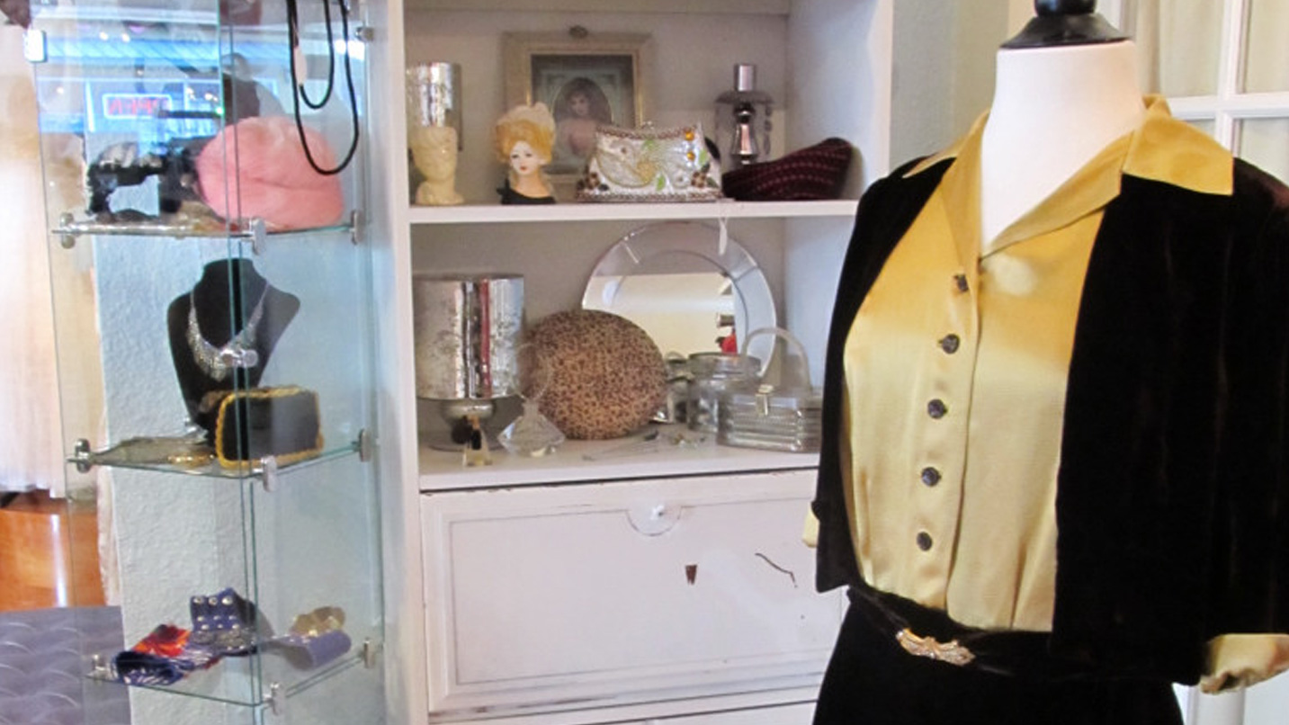 A shirt and sweater on a mannequin.