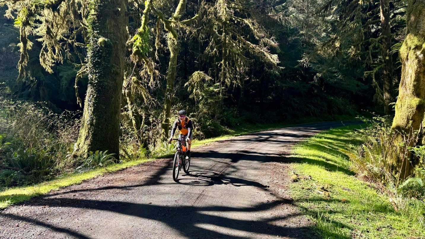 Biking on a gravel road in the forest.