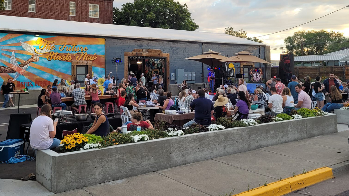 Live music plays at a busy outdoor patio of a restaurant in Burns.