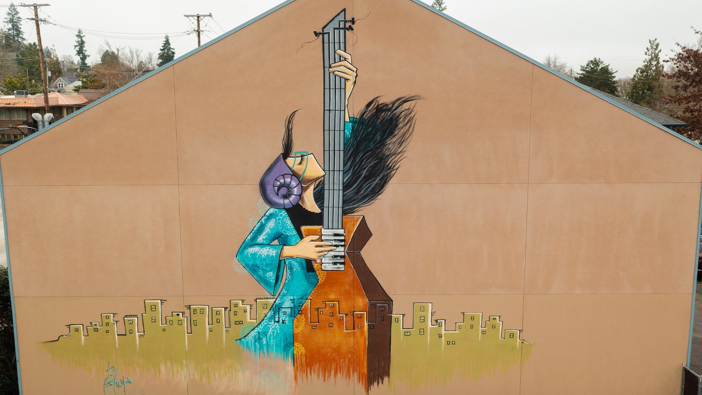 A mural of a woman playing guitar.