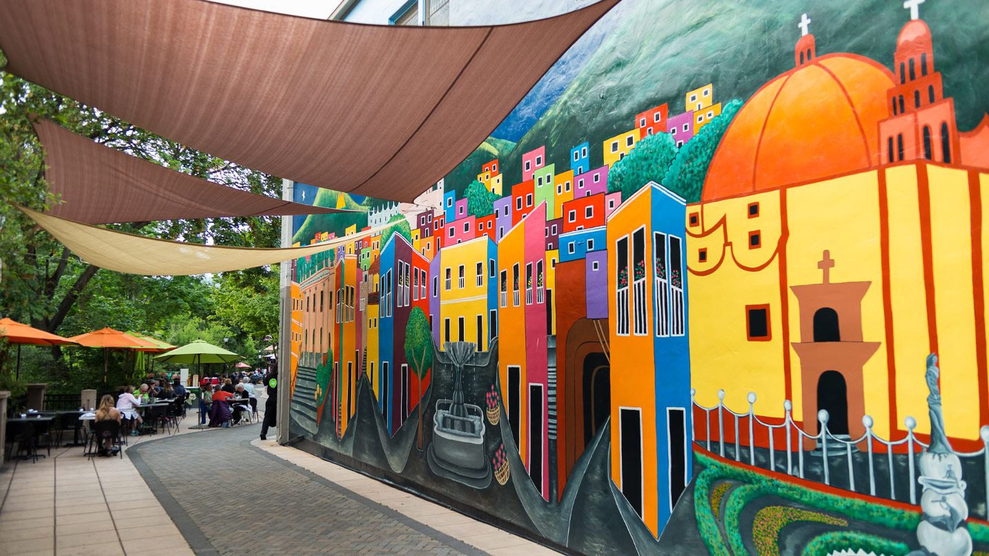 A brightly painted Mexican scene along a walkway.