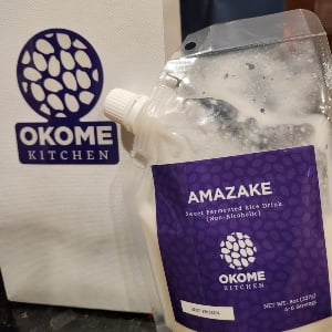 Plastic pouch of white liquid with purple label