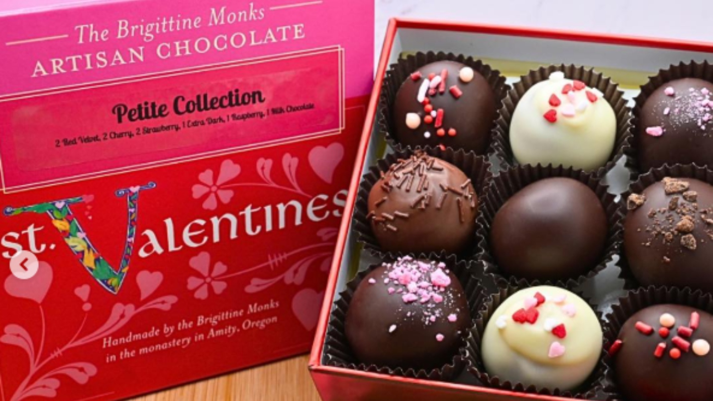 Square-shaped box of chocolates with sprinkles and pink/red box
