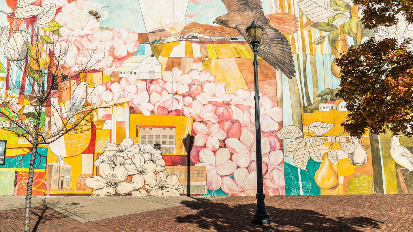 A brightly-painted mural showing blossoms and pears.