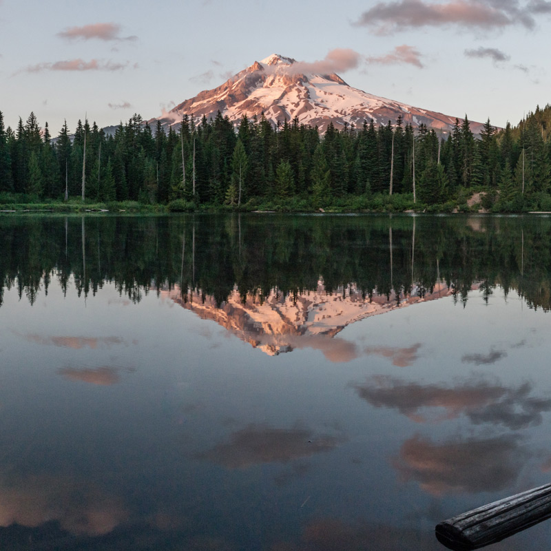 A snow-capped mountain reflected in a lake.
