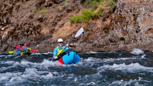 The author paddling through rapids on the Minam River.