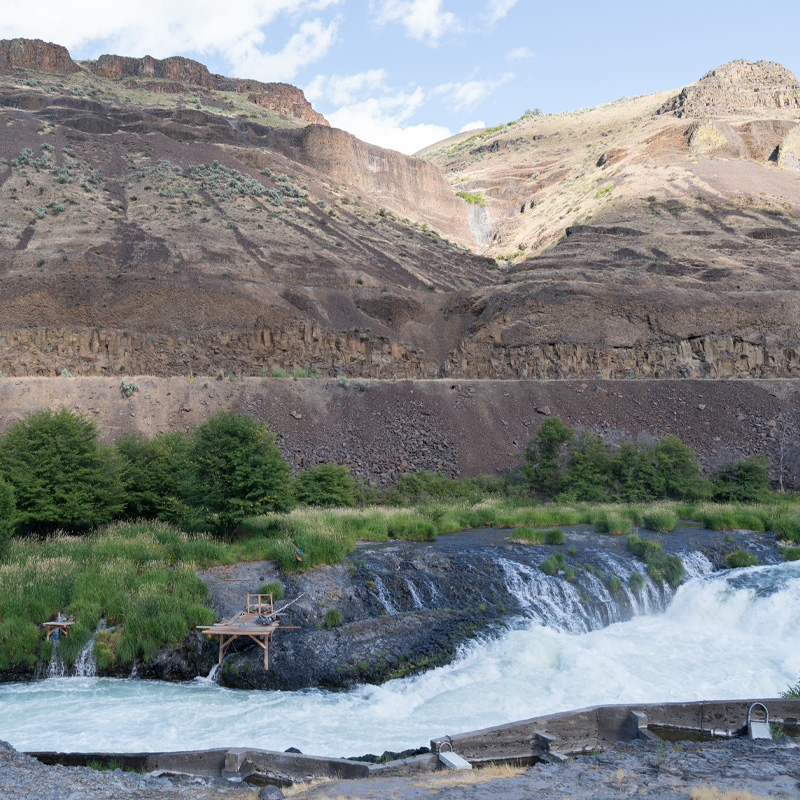 A wooden platform over a waterfall.