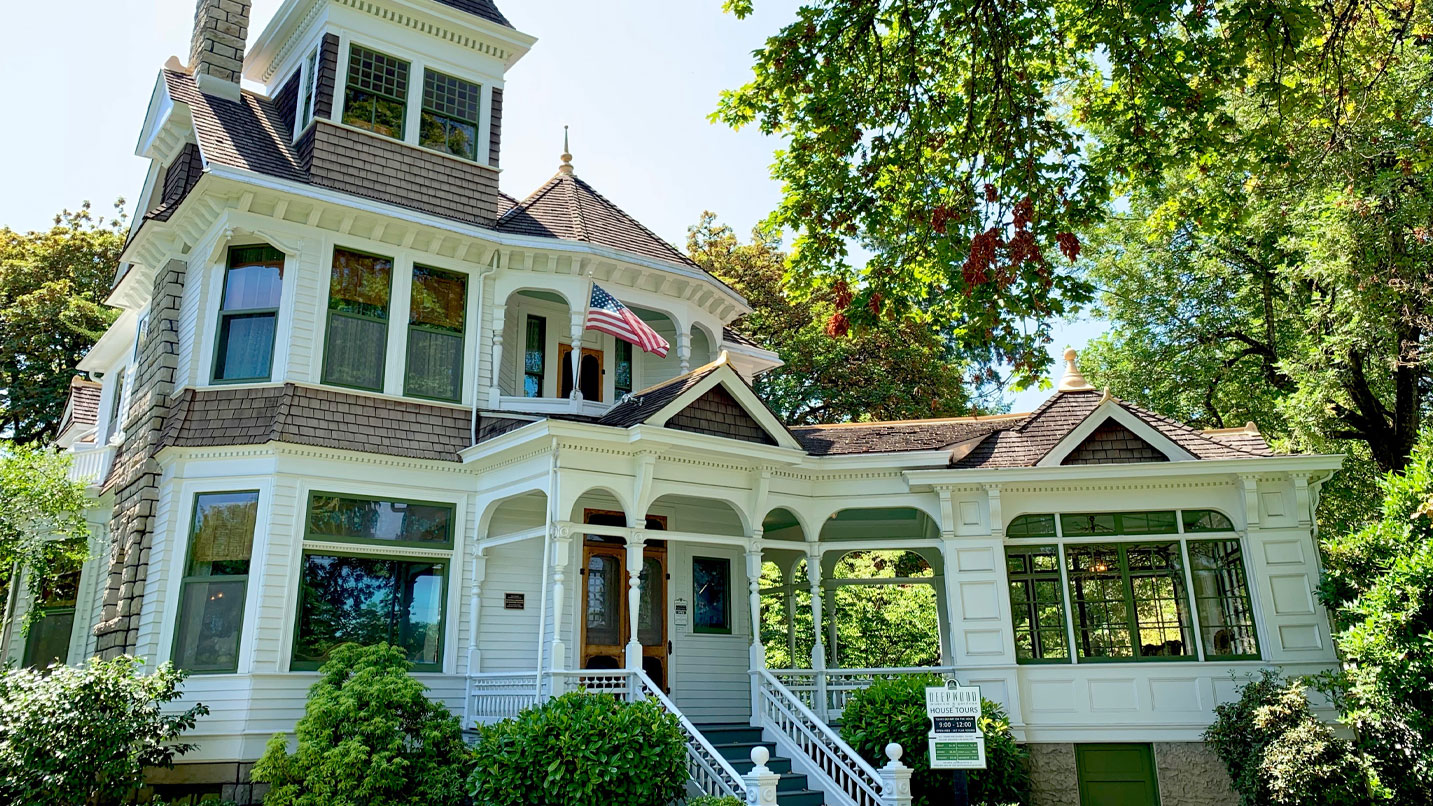 An adorned three story home with lots of windows.
