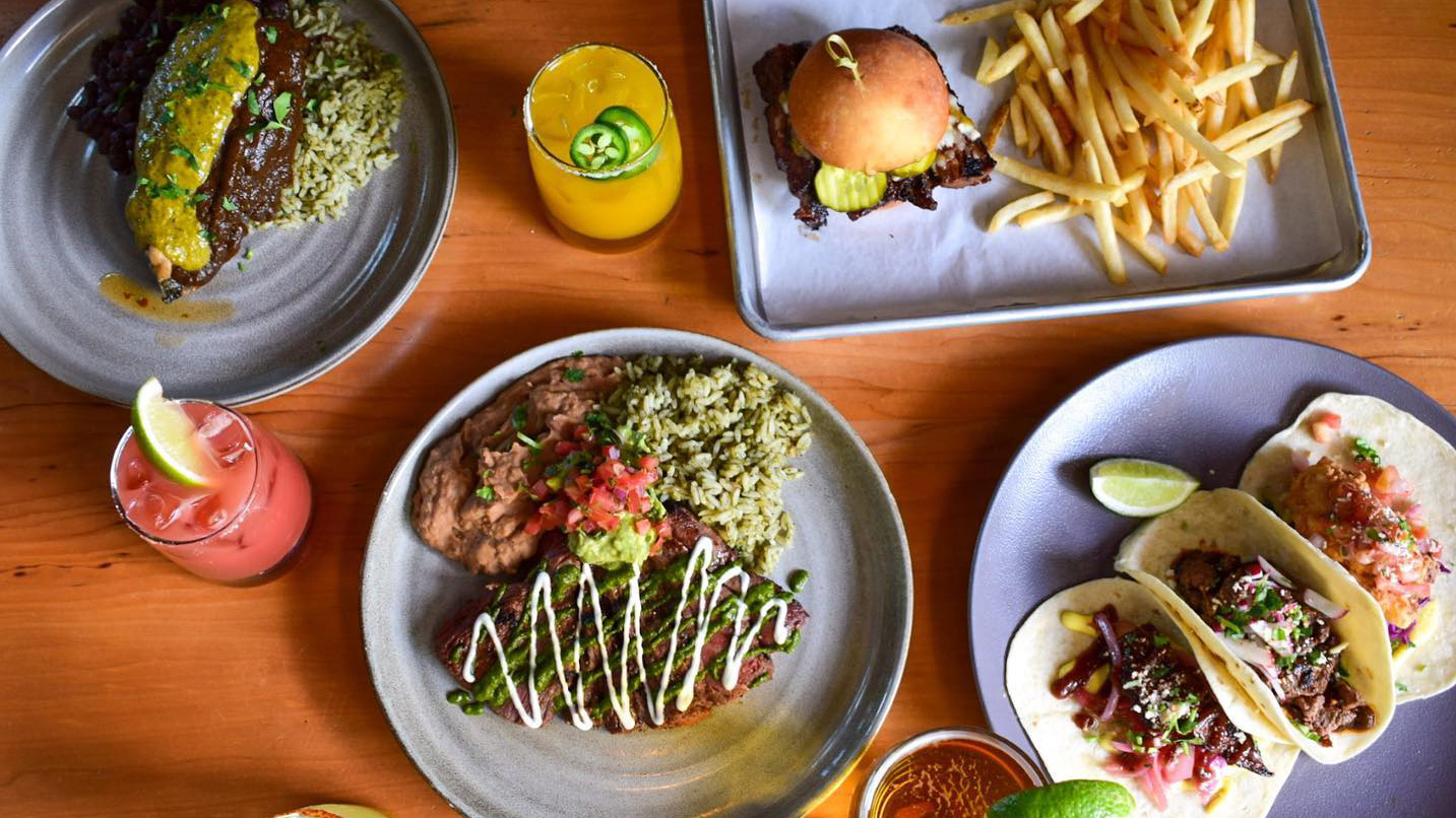A table with plates of food and drinks.