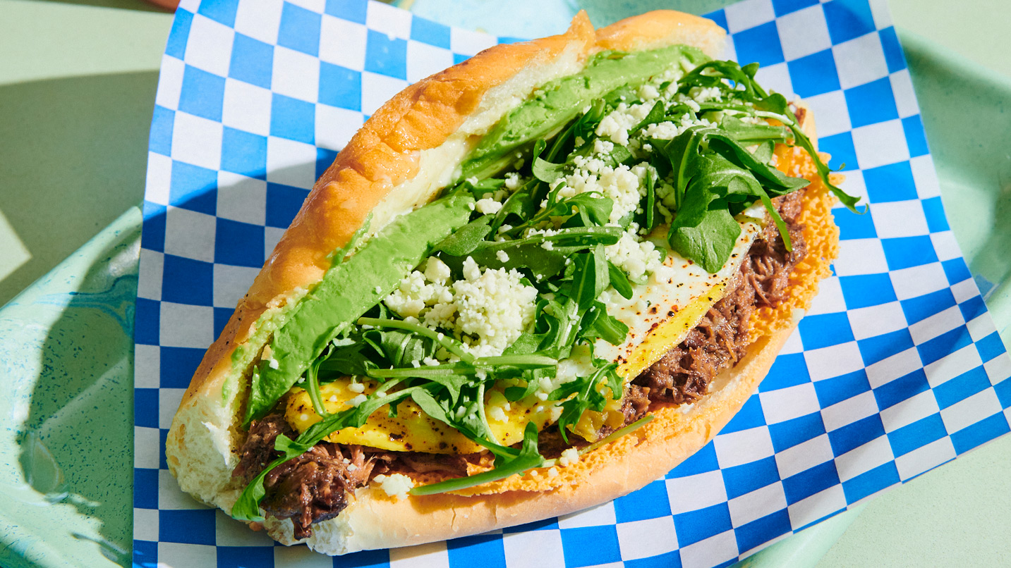A torta - a sandwich on a telera (hoagie-like bread) topped with chorizo, cheese, arugula and avocado.