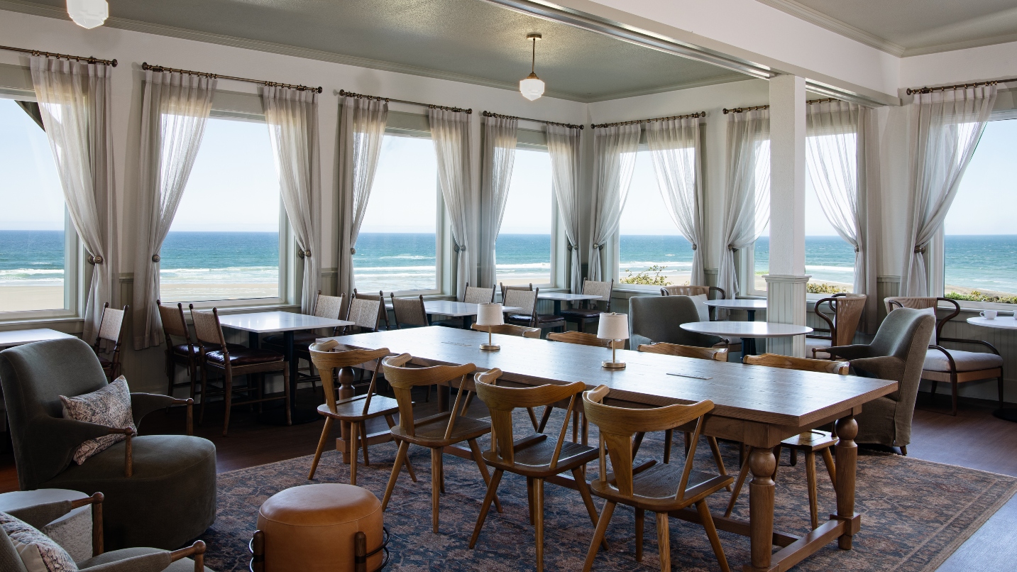Restaurant dining room with large windows overlooking the beach and ocean