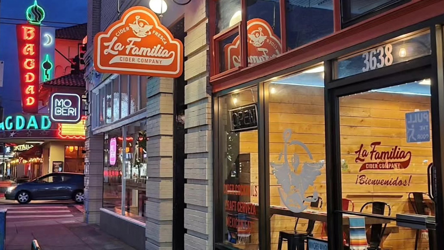 Exterior of storefront and sign reading La Familia Cider Company.