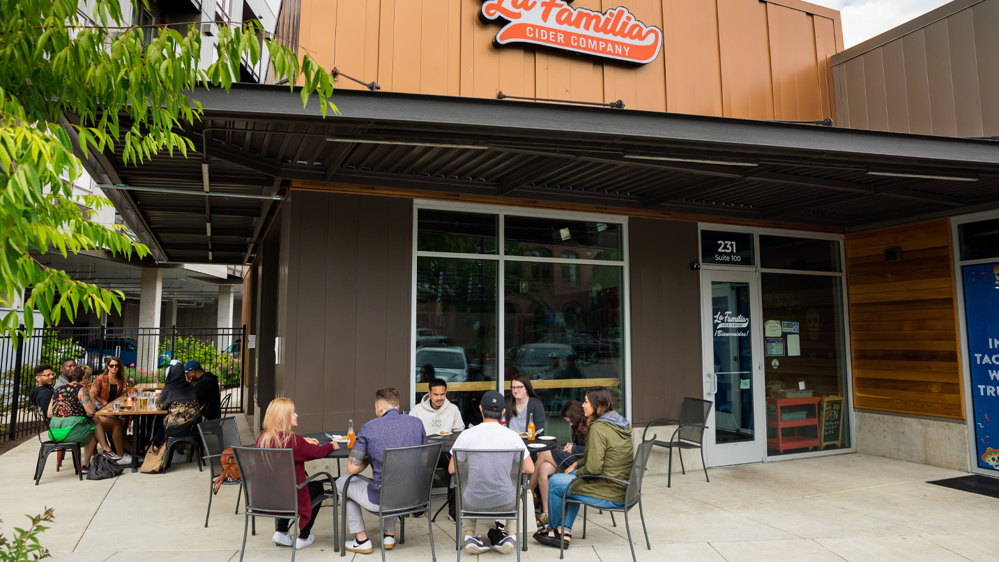 People at an outdoor patio at La Familia Cider Company restaurant.