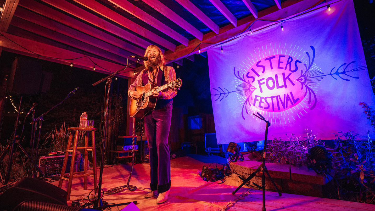 A musician plays on a stage.