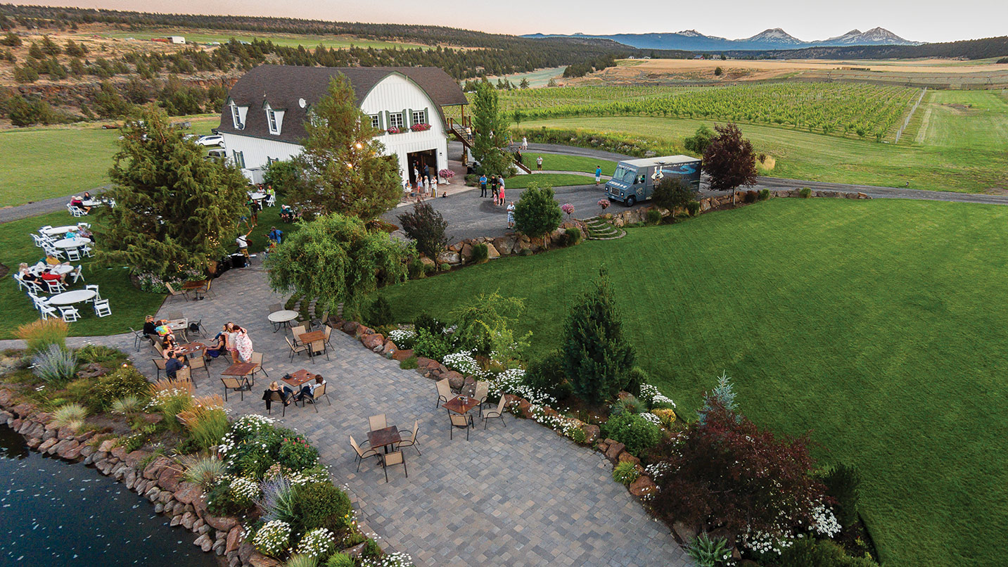 Aerial view of a winery estate, including barn room and outdoor seating.