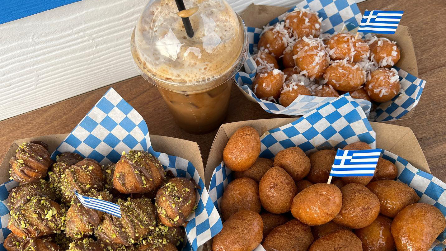 Small fried dough balls with toppings like pistachio chocolate and coconut.