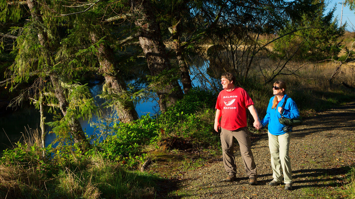 A couple walking along a nature trail.