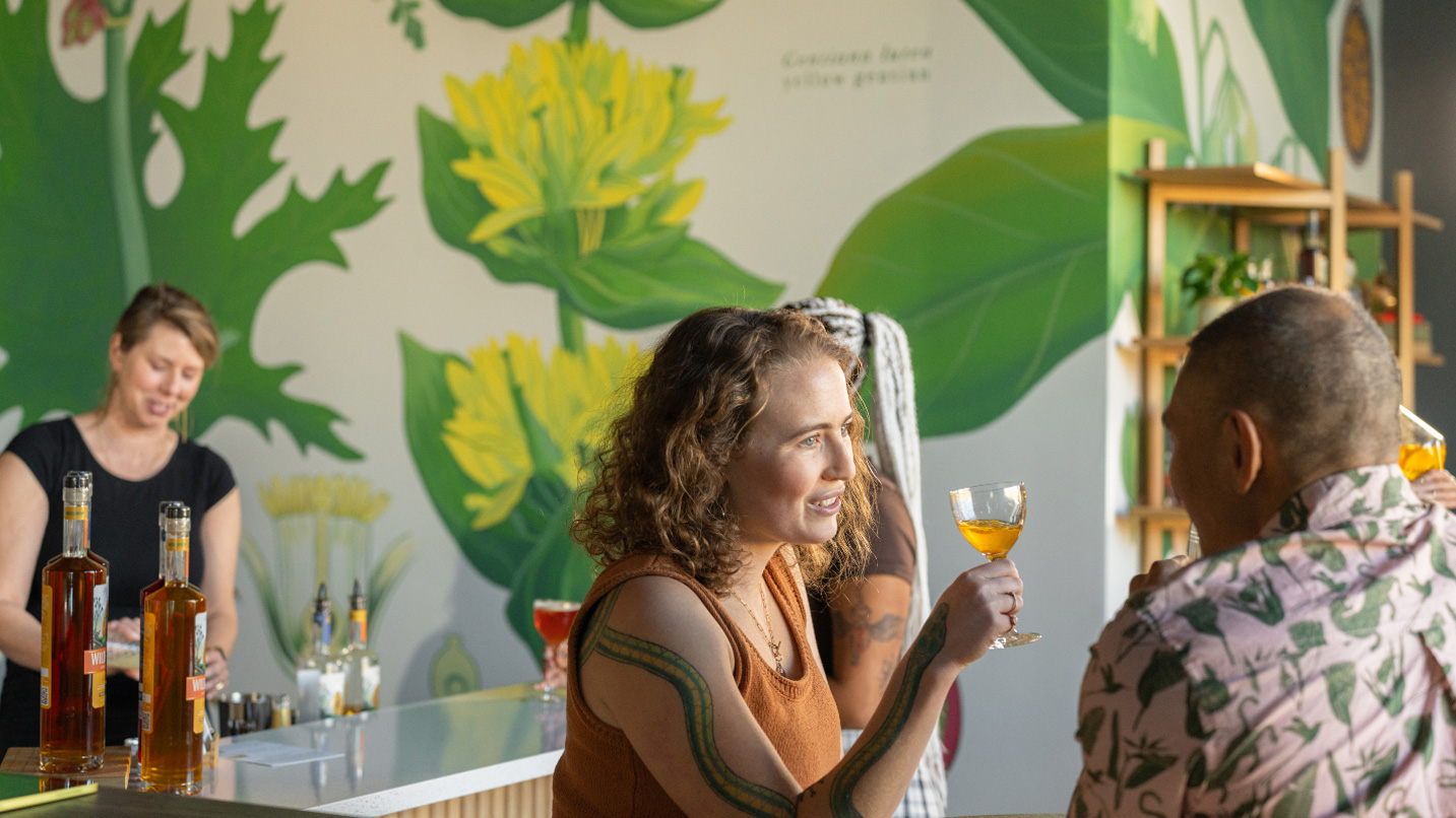 People drinking in a brightly lit tasting room.