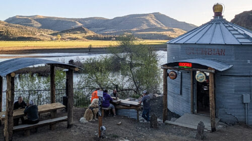 A former silo is a now a bar alongside a river.