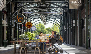 Couple shares a meal at an outdoor cafe in summer.