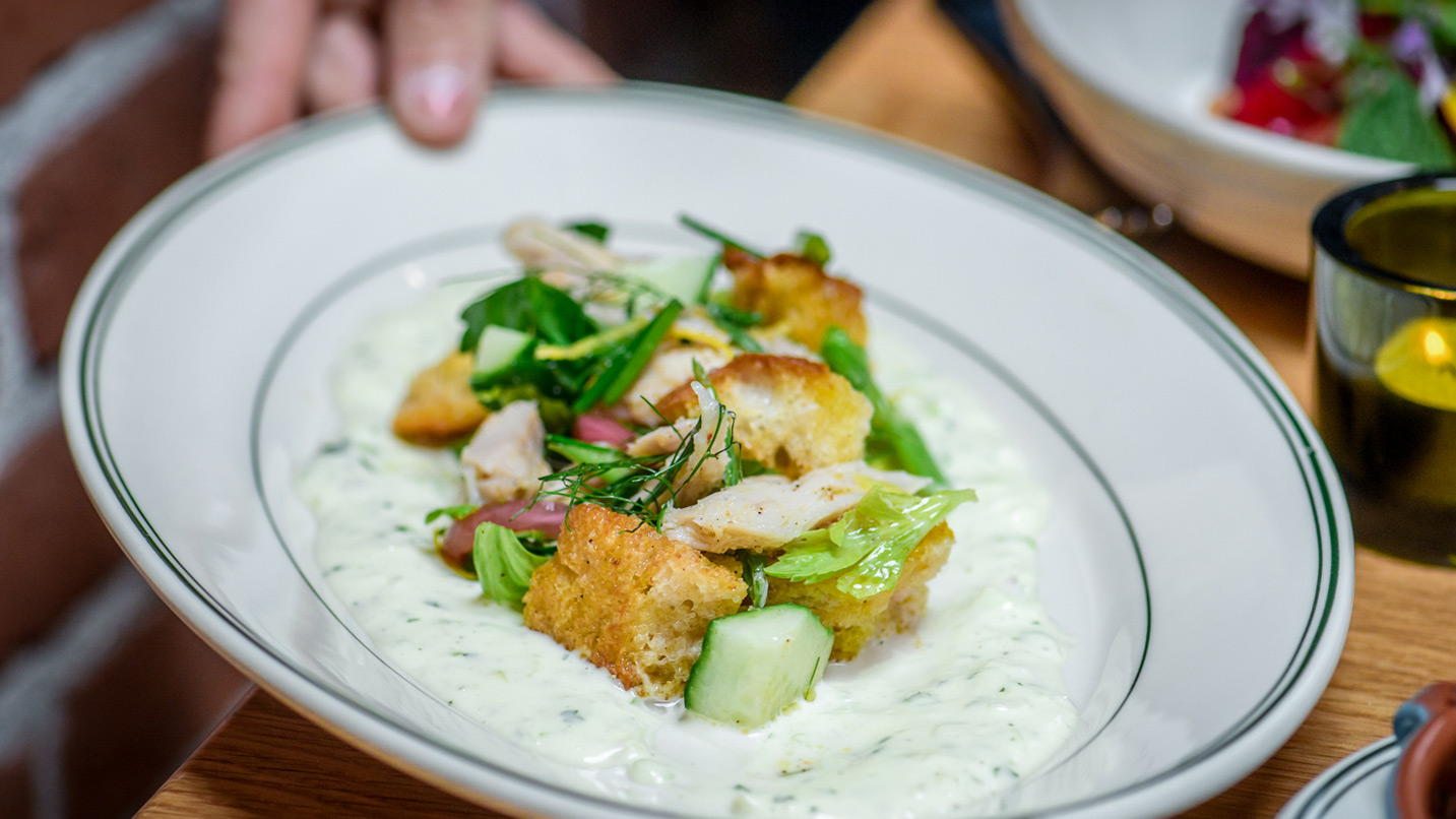 A person holding a plate of food.