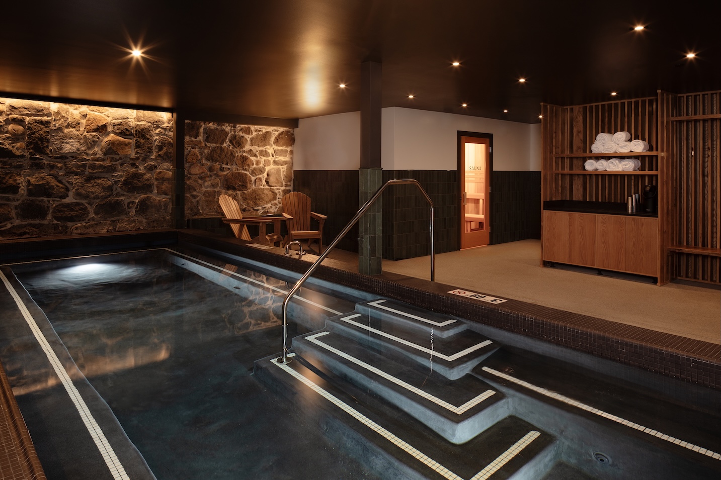 An overview photo of the basement-level warm pool, with a sauna in the background.