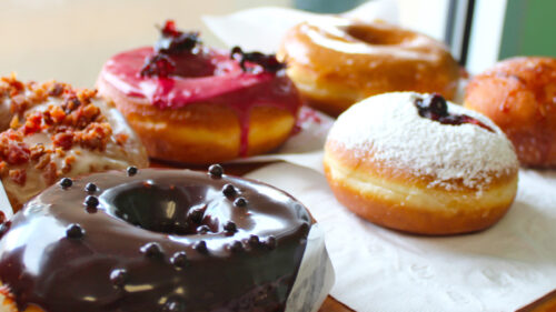 An array of donuts, from chocolate covered to maple bacon, jelly-filled with powder sugar and other flavors.