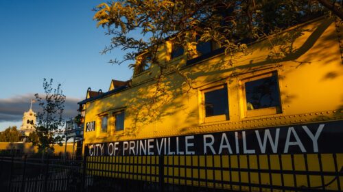 Yellow railcar closeup featuring the words City of Prineville Railway