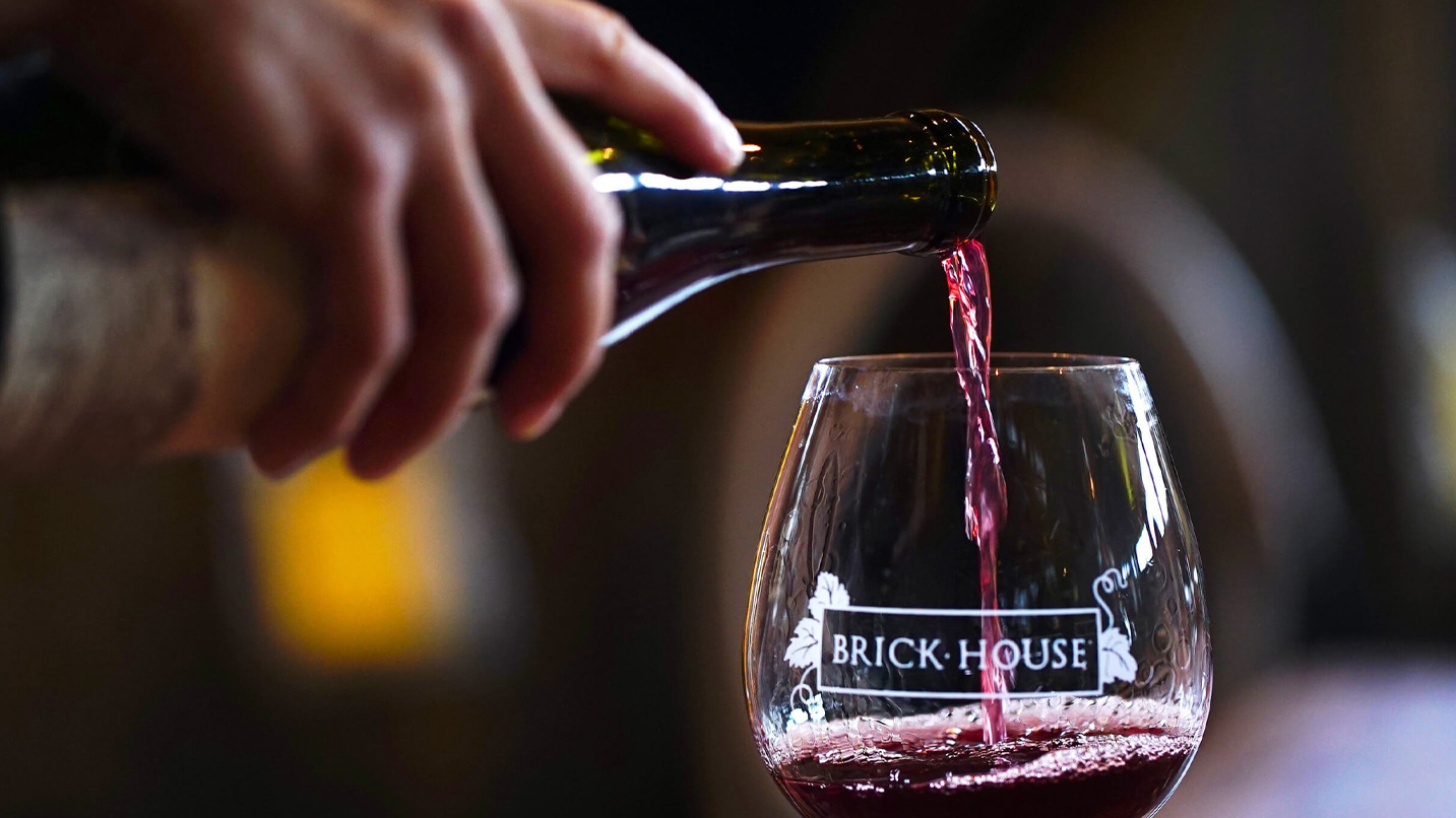 Red wine being poured into a glass.