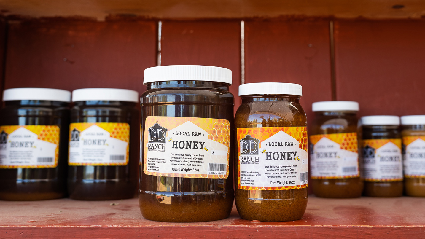 Jars of honey on a shelf.
