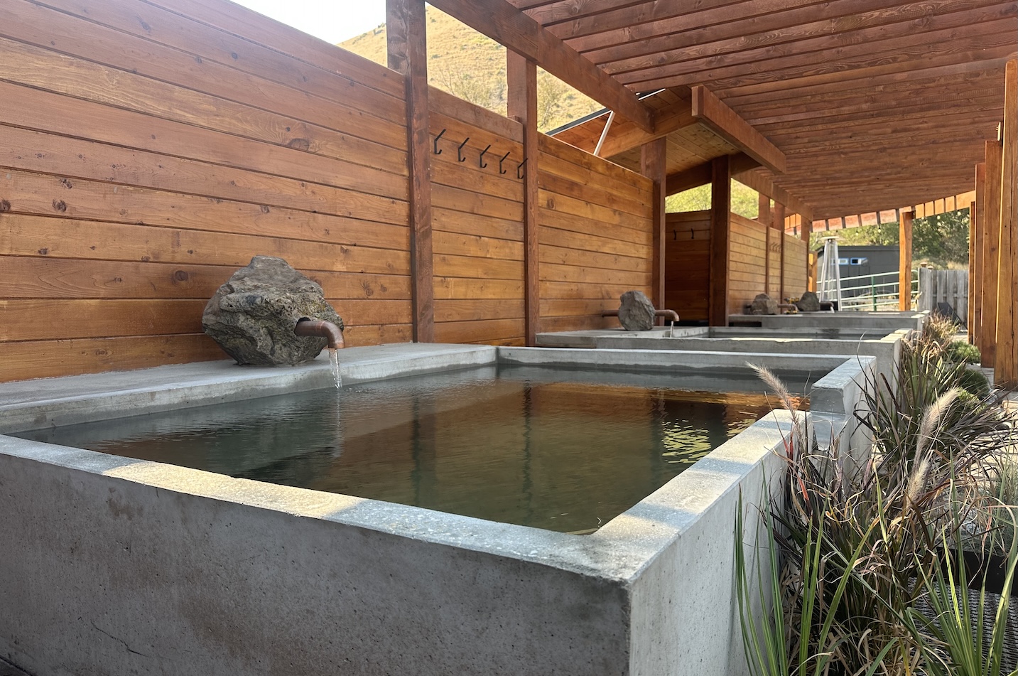 A trio of elegant concrete soaking tubs. 