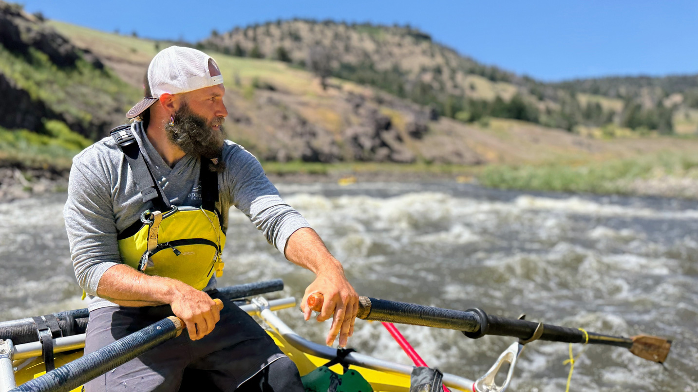 A guide floating a boat on the river.