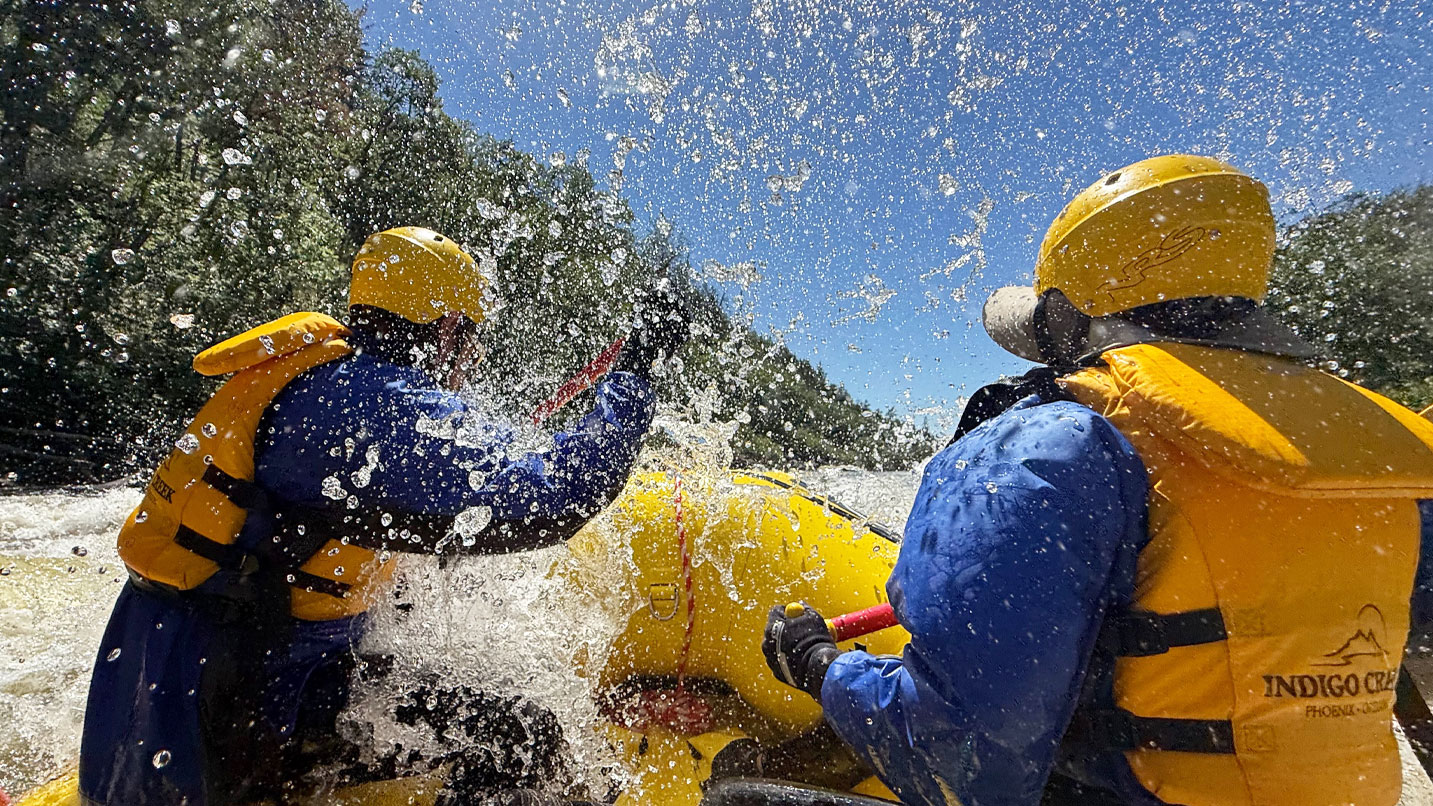Rafters getting spashed on a whitewater section of the river.