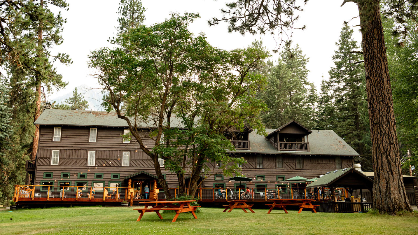 A rustic lodge and large lawn.