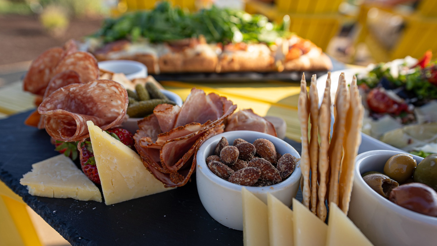 Charcuterie plate with meat, cheese, nuts and crackers.
