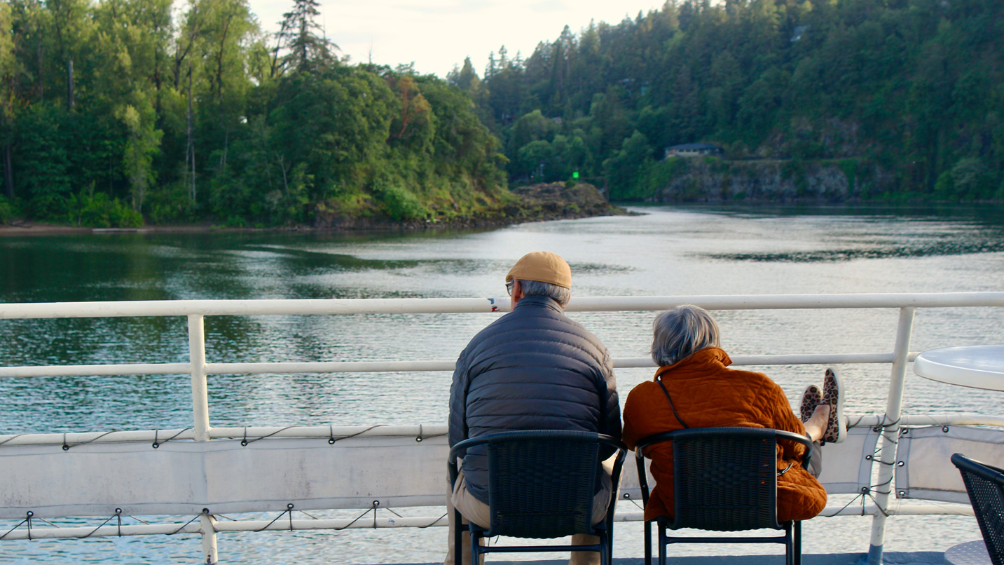 Two people sitting on the boat's deck.